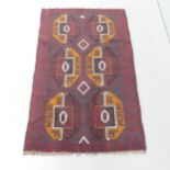A red-ground Baluchi rug. 146x89cm.
