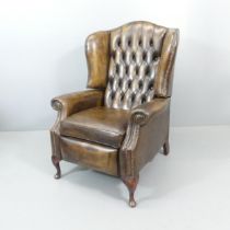 A button-back leather upholstered reclining armchair. Overall 80x112x90cm, seat 48x50x54cm.