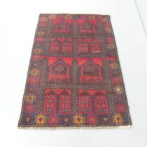 A red-ground Persian design rug. 135x90cm.