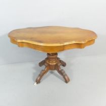 A Victorian walnut centre table of serpentine form on mahogany base. 115x68x69cm.