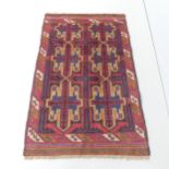 A red-ground Baluchi rug. 135x84cm.