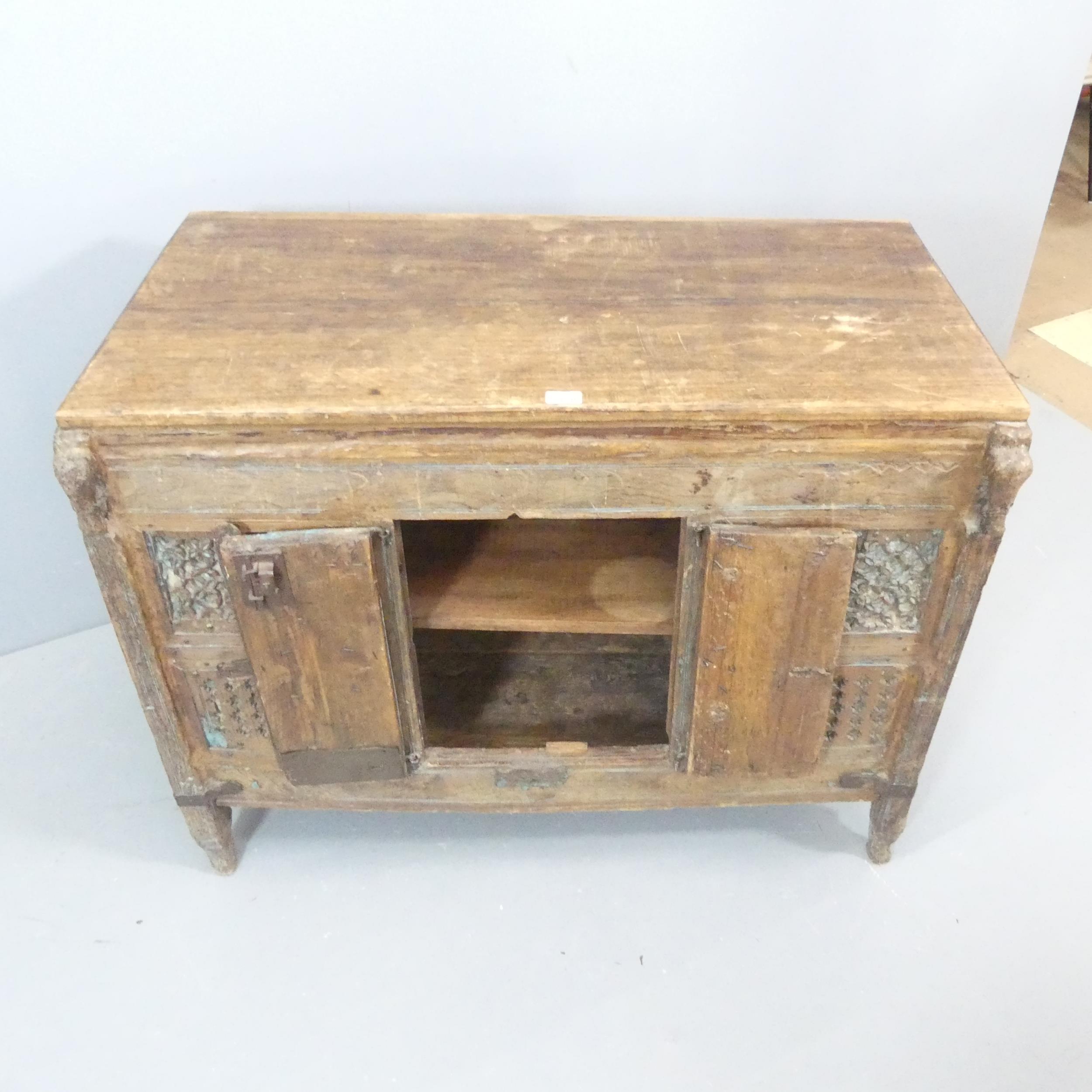 An early 19th century carved Indian hardwood Damchiya dowry chest with later top and shelf, with - Image 2 of 2