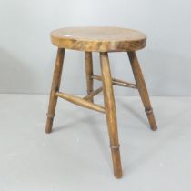 An elm-seated stool. Height 44cm.