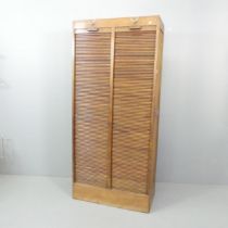 An early 20th century oak twin tambour fronted filing cabinet. 82x181x38cm. Shelf depth 32cm.