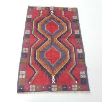 A red-ground Baluchi rug. 135x84cm.