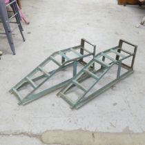 A pair of vintage metal car ramps.