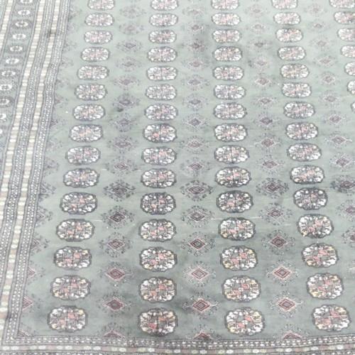 A large green-ground Tekke carpet. 368x280cm. - Image 2 of 3
