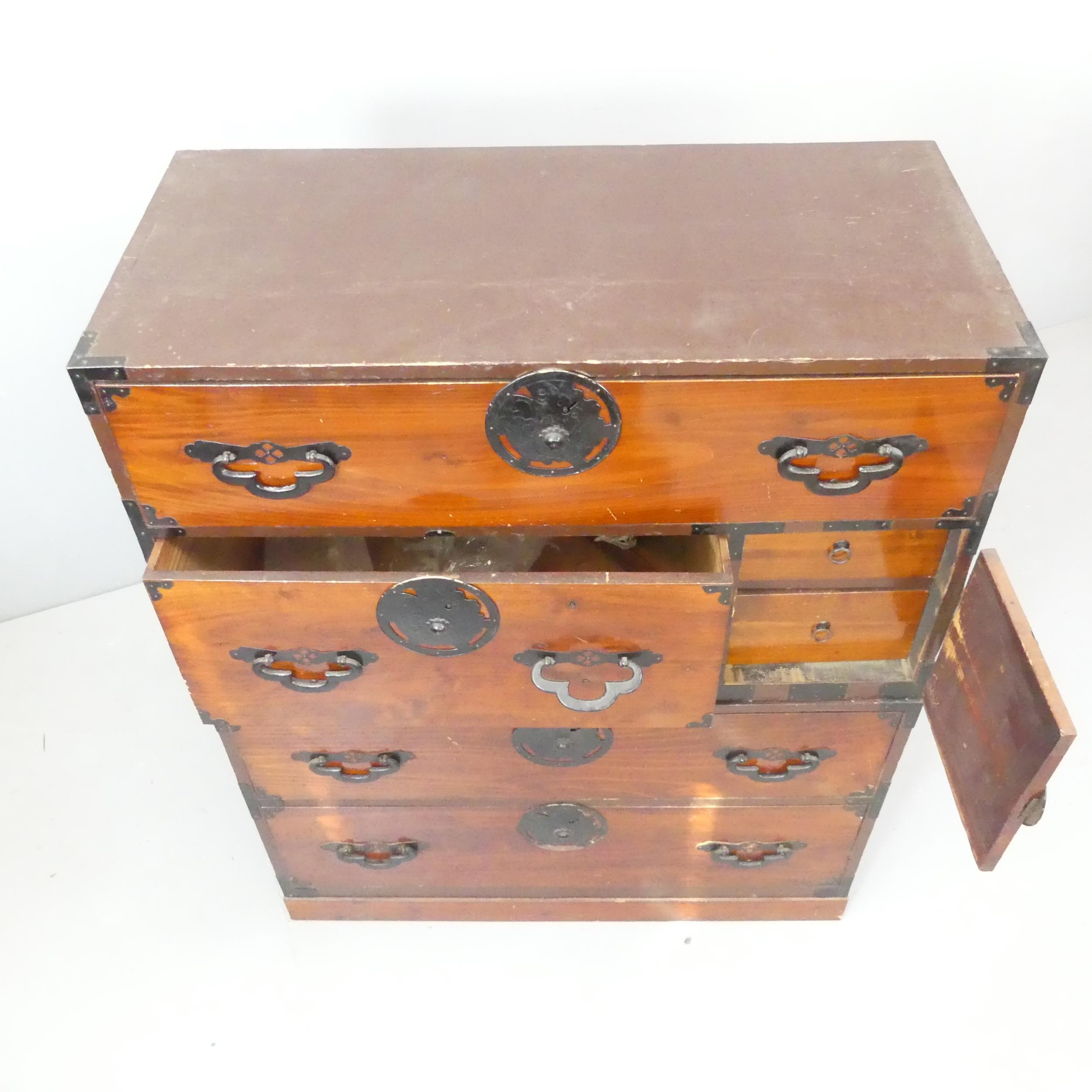 A Japanese kiri-wood two-section Tansu chest of four long drawers, with cupboard door revealing - Image 2 of 2