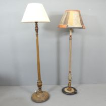 An early 20th century oak standard lamp on pedestal base, height to bayonet 175cm, and another