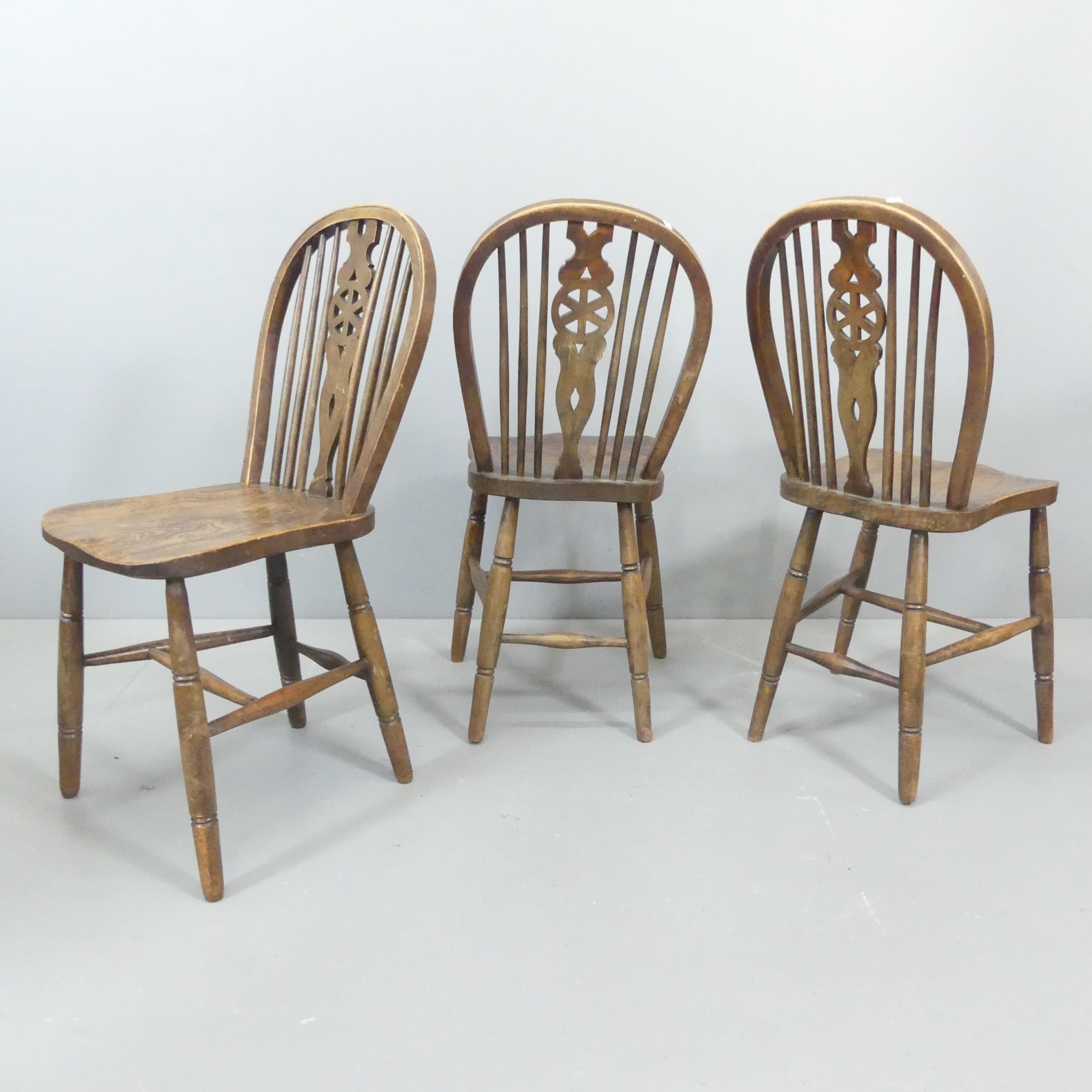 Three 19th century elm-seated wheel back dining chairs. Good condition, with some signs of age and - Image 2 of 2