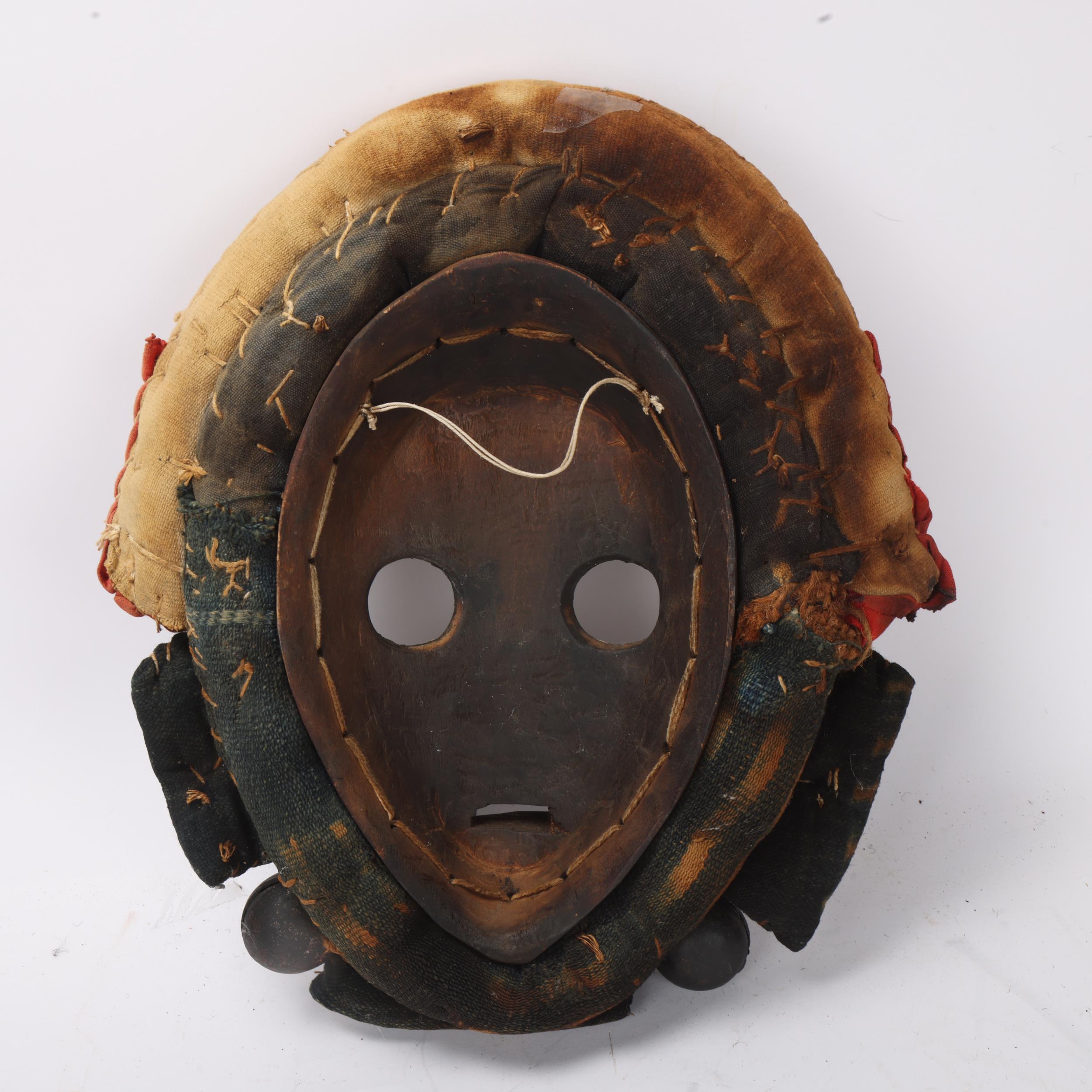 A Dan hardwood Tribal mask in cowrie shell and textile surround, height 31cm - Image 3 of 3