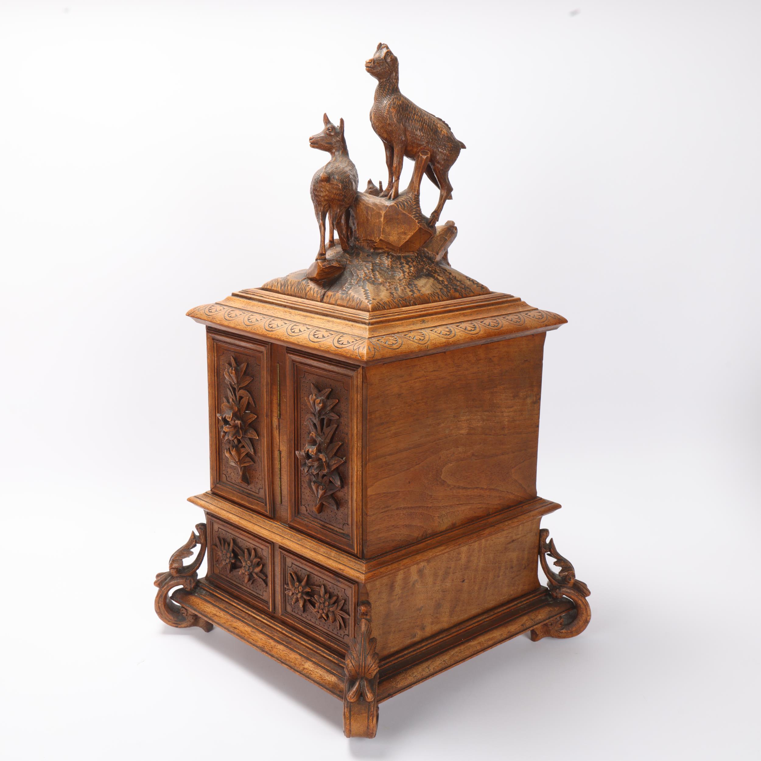 An ornate 19th century Black Forest table cabinet, the lid surmounted a carved wood group of deer, 2 - Image 3 of 3