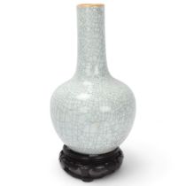 A Chinese crackle glaze porcelain onion-shaped vase on carved wood stand, overall height 39cm Good