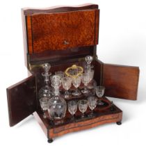 A 19th century amboyna and kingwood table-top liqueur cabinet, with serpentine-shaped front, the
