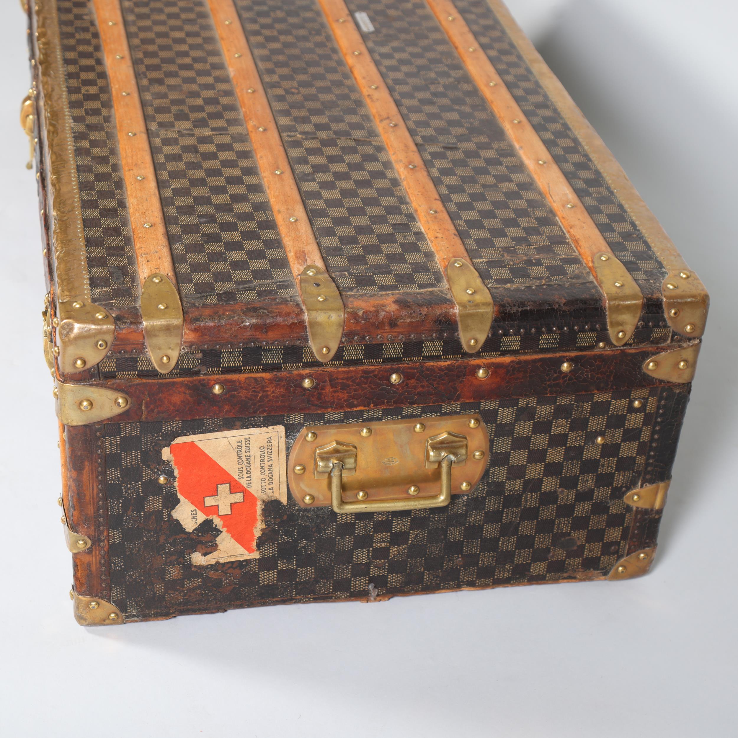 A Vintage French travelling trunk, brass wood and leather-bound with printed canvas panels, Damier - Image 2 of 6