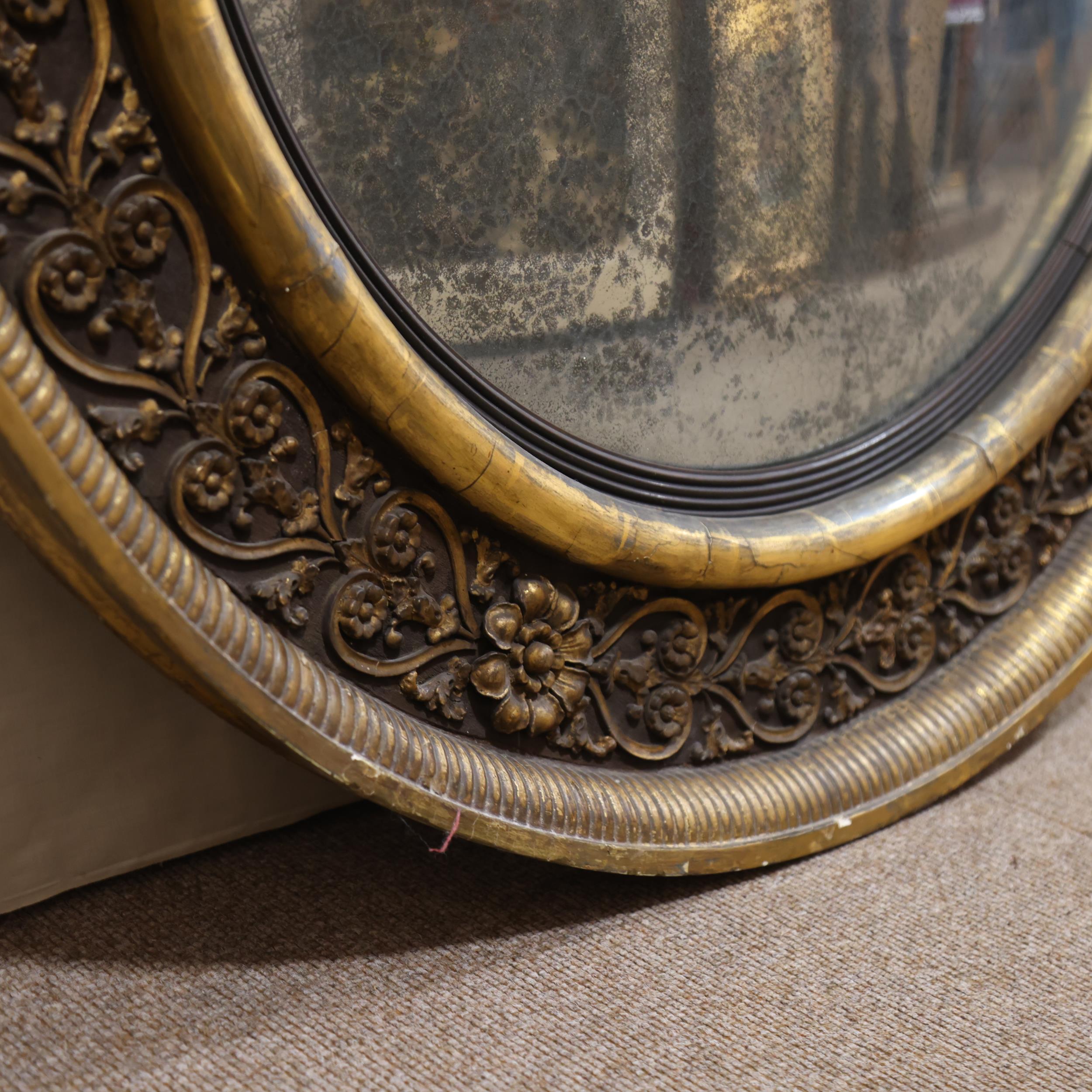 A large Georgian convex mirror, with gilded relief carved wood and gesso surround, original oxidised - Image 3 of 3