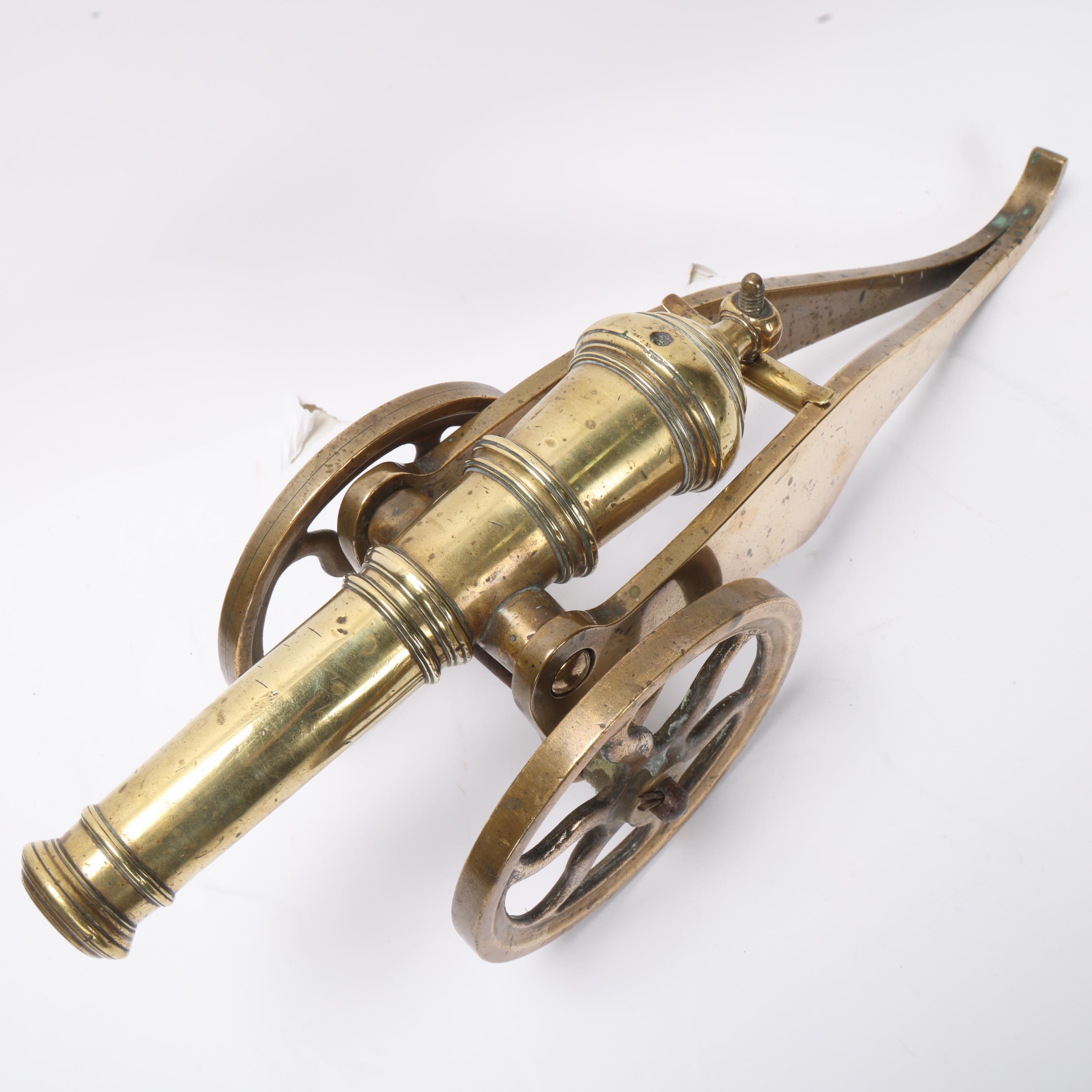 A good quality brass table cannon, 18th or 19th century with ringed barrel on wheeled carriage, - Image 3 of 3