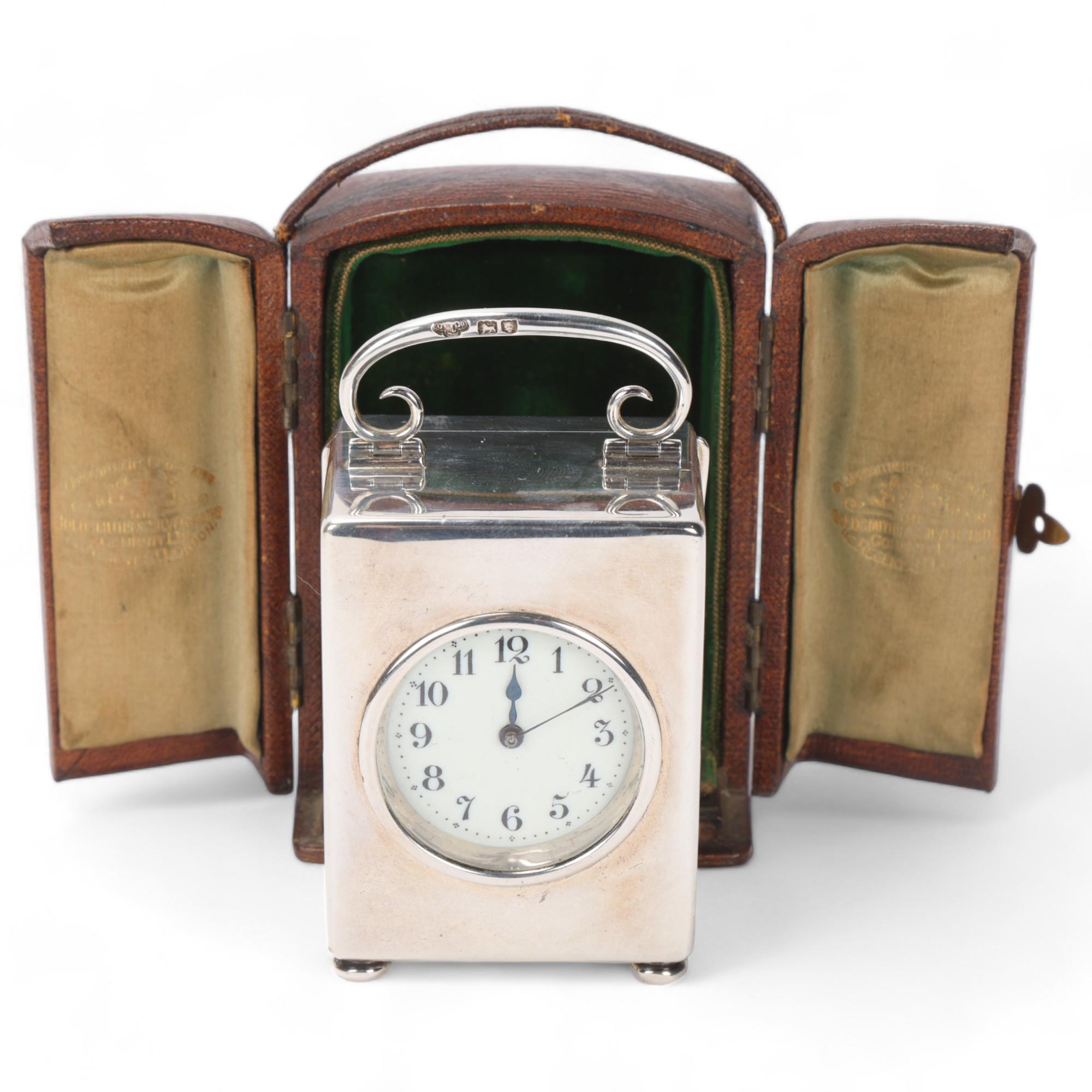Late Victorian silver carriage clock, enamel dial with glass front and scrolled swing handle, by