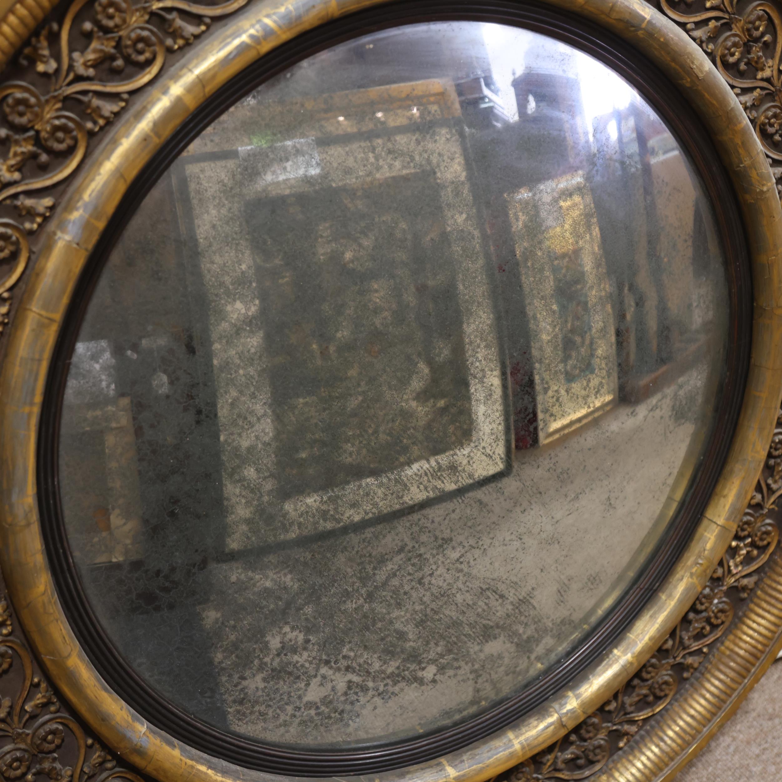 A large Georgian convex mirror, with gilded relief carved wood and gesso surround, original oxidised - Image 2 of 3