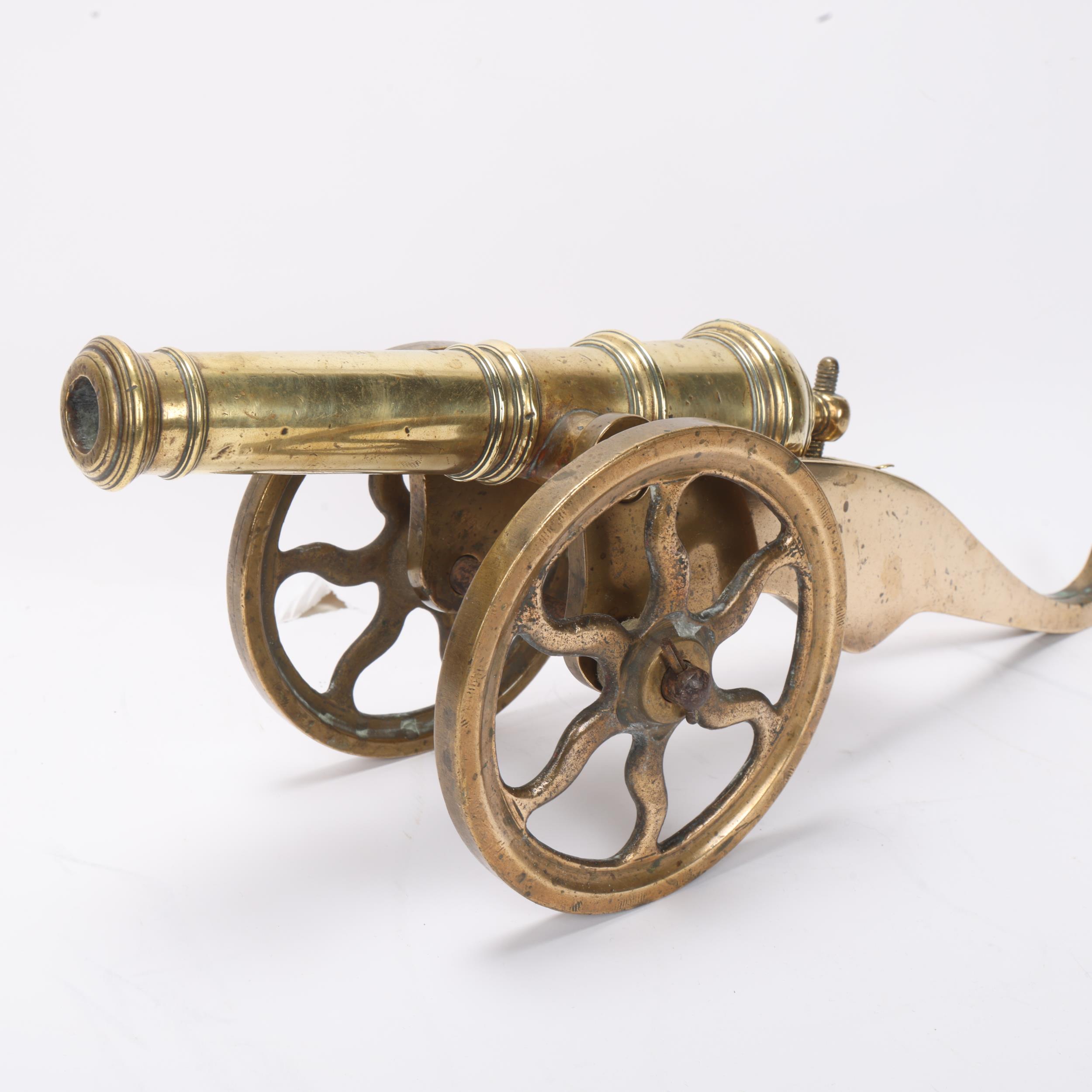A good quality brass table cannon, 18th or 19th century with ringed barrel on wheeled carriage, - Image 2 of 3