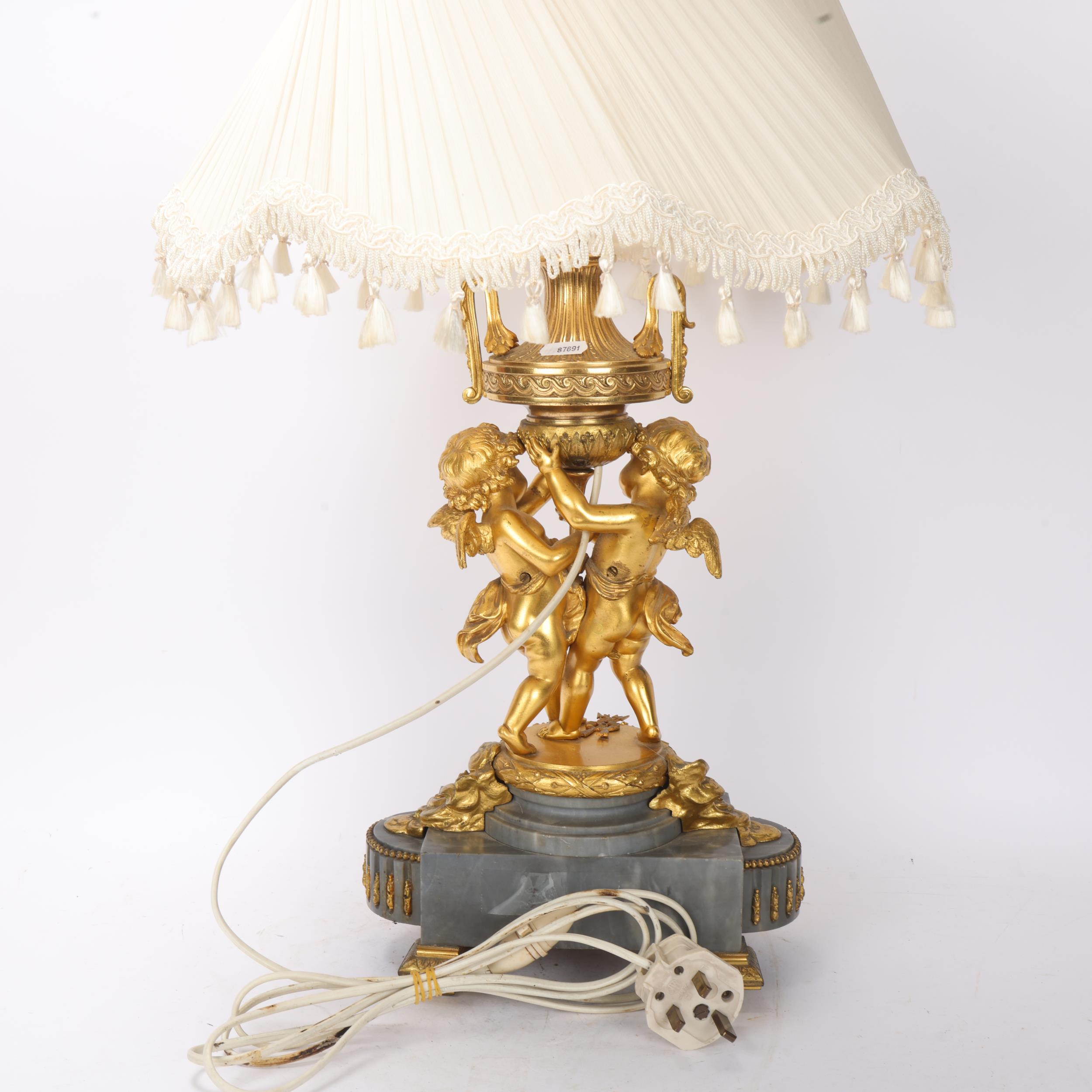 An ornate French gilt-bronze table lamp, supported by 2 cherubs, probably late 19th century, on - Image 3 of 3