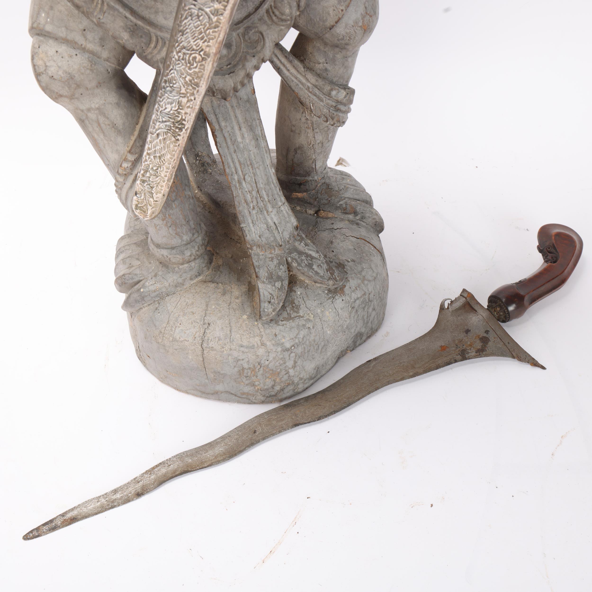 A Malayan carved wood grotesque figure Kris stand, together with a Kris dagger in white metal - Image 2 of 3