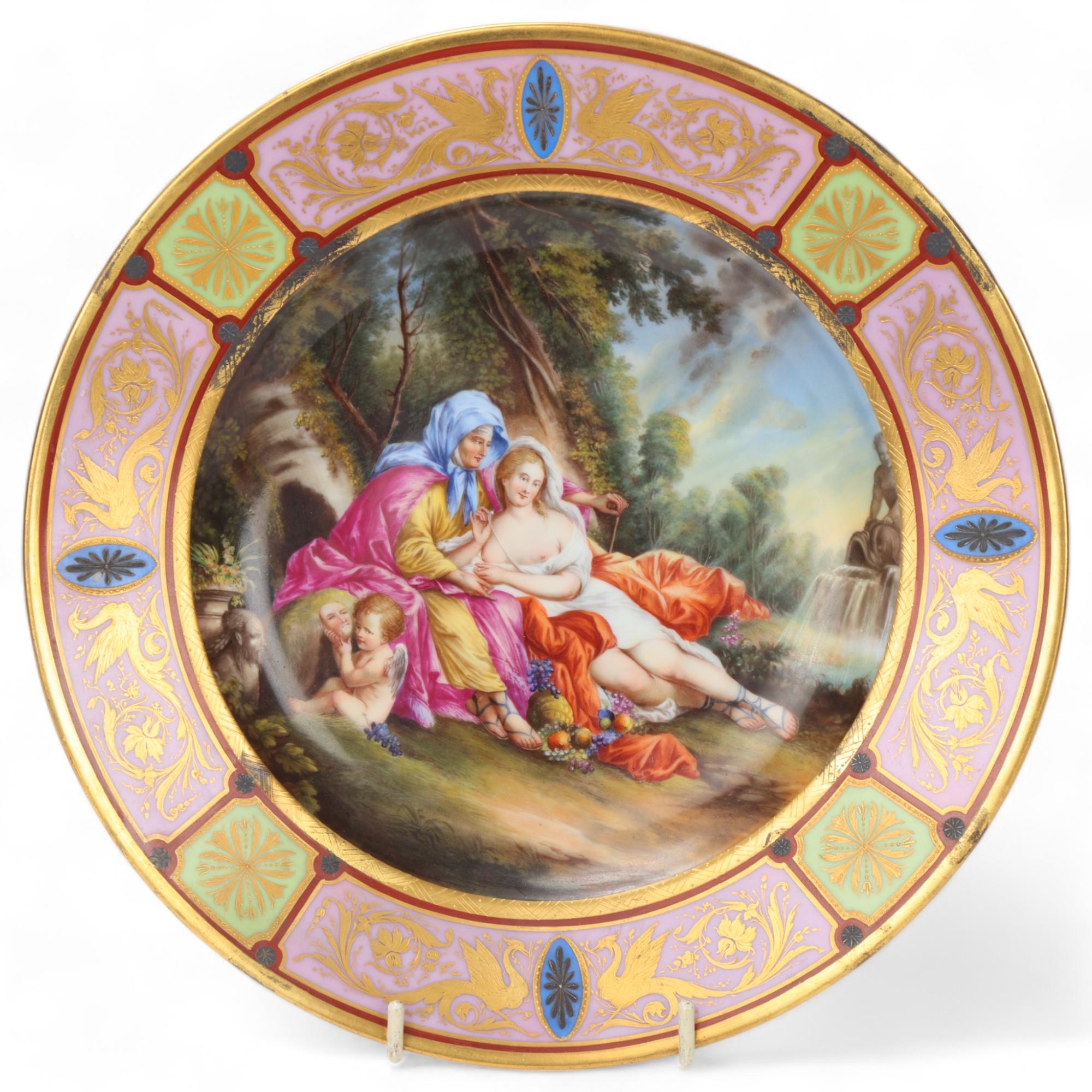 A Vienna porcelain plate depicting Venus and Armida, gilded border, diameter 24.5cm Very good