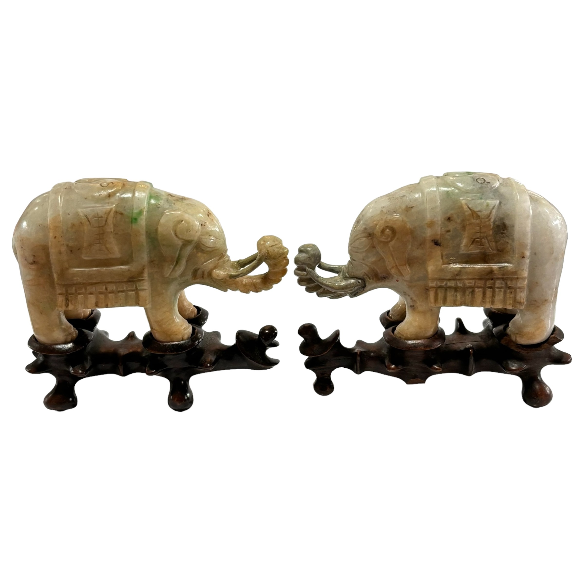 A small pair of Chinese carved jade elephant on carved wood stand, length 10.5cm