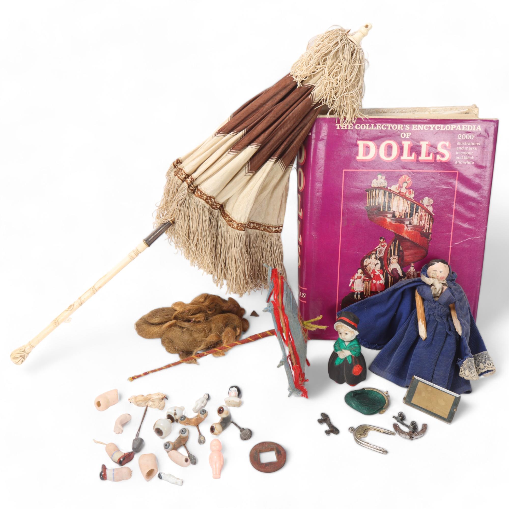 A collection of doll related items, doll's house items, spare limbs, peg doll and a book, The