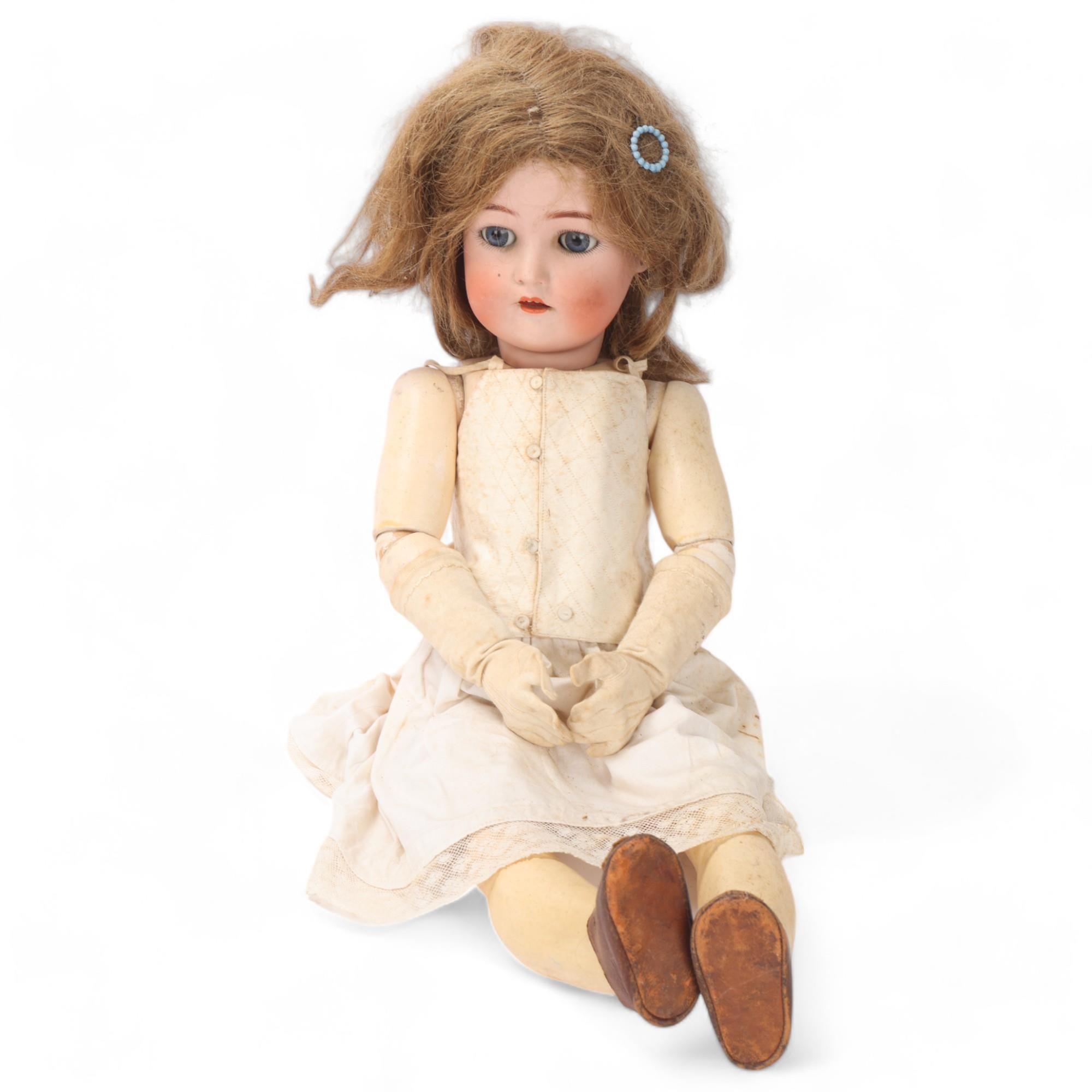 A bisque porcelain-headed girl doll, made by Kammer & Reinhardt using Simon & Halbig bisque head,