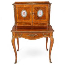 An ornate French kingwood and rosewood writing desk, circa 1900, the upper part fitted with 2