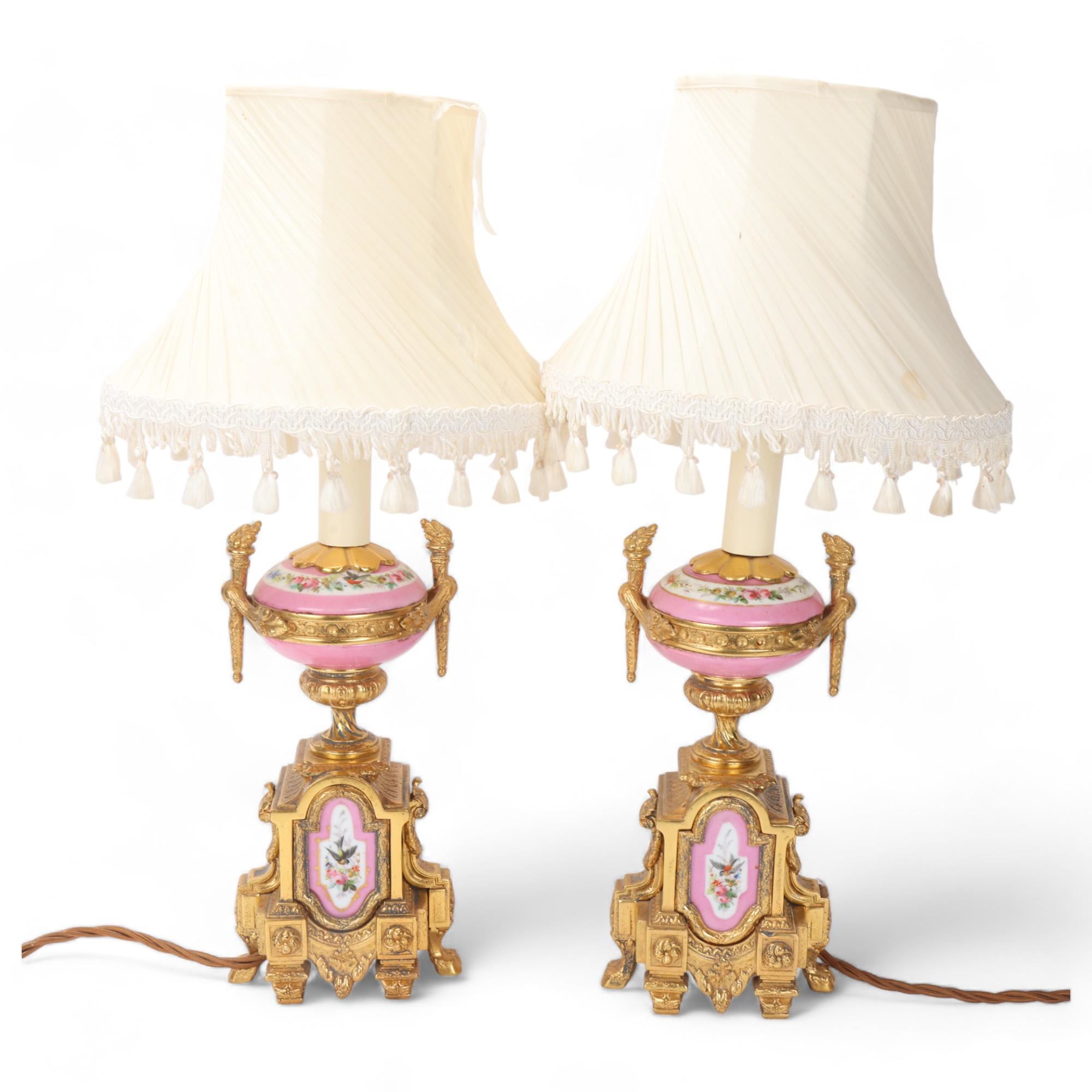 Pair of French ormolu and porcelain table lamps, circa 1900, with hand painted panels depicting