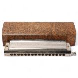 A Hohner 64 Chromonica harmonica, cased
