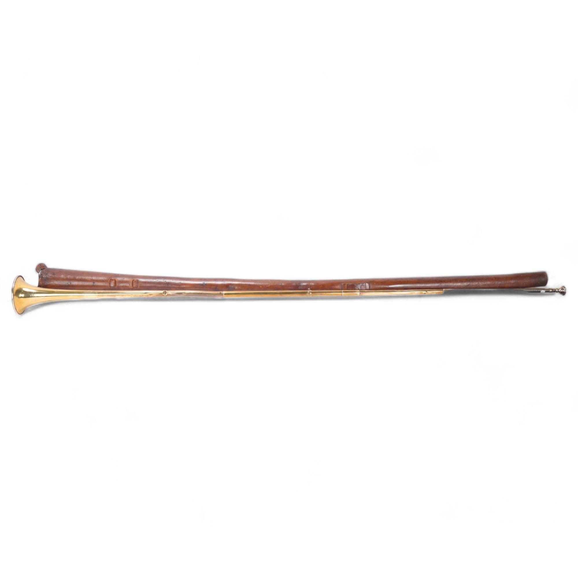 A brass coaching horn, by Army & Navy of London, length 145cm, in leather holder Several very