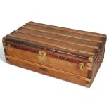 A Vintage French travelling trunk, brass wood and leather-bound with canvas panels, original label