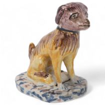 A 19th century Delft pottery dog, height 8.5cm Both ears have chipped tips, otherwise good condition