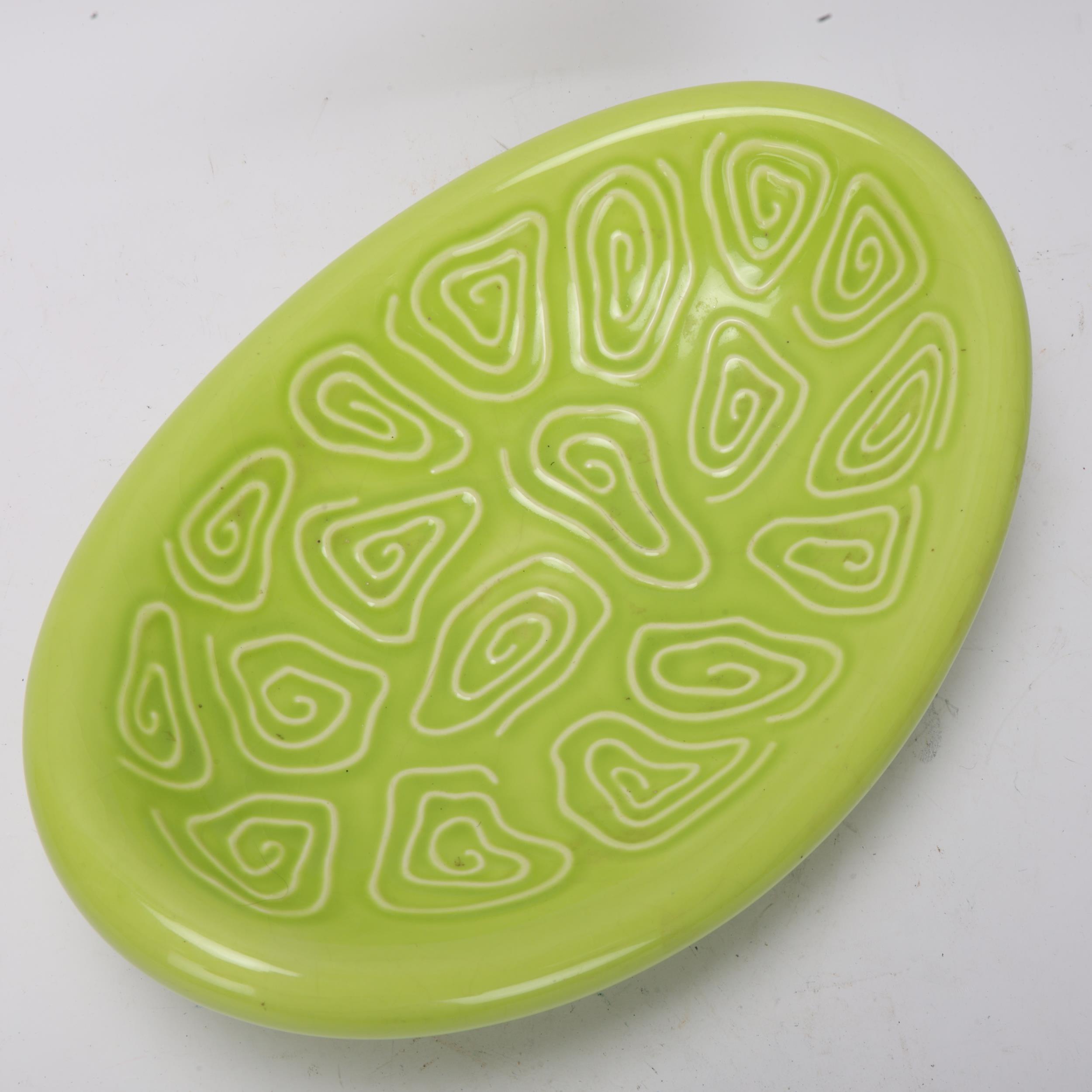 A mid 20th century elliptical centre dish with lime green glaze, indistinct makers mark under - Image 2 of 3
