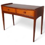 JOHN HERBERT for A Younger Ltd, a teak console table or desk with two drawers, makers label to