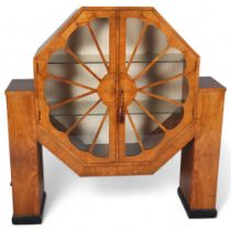 An Art Deco Octagonal shaped display cabinet, walnut veneer cabinet on ebonised feet, with shelves