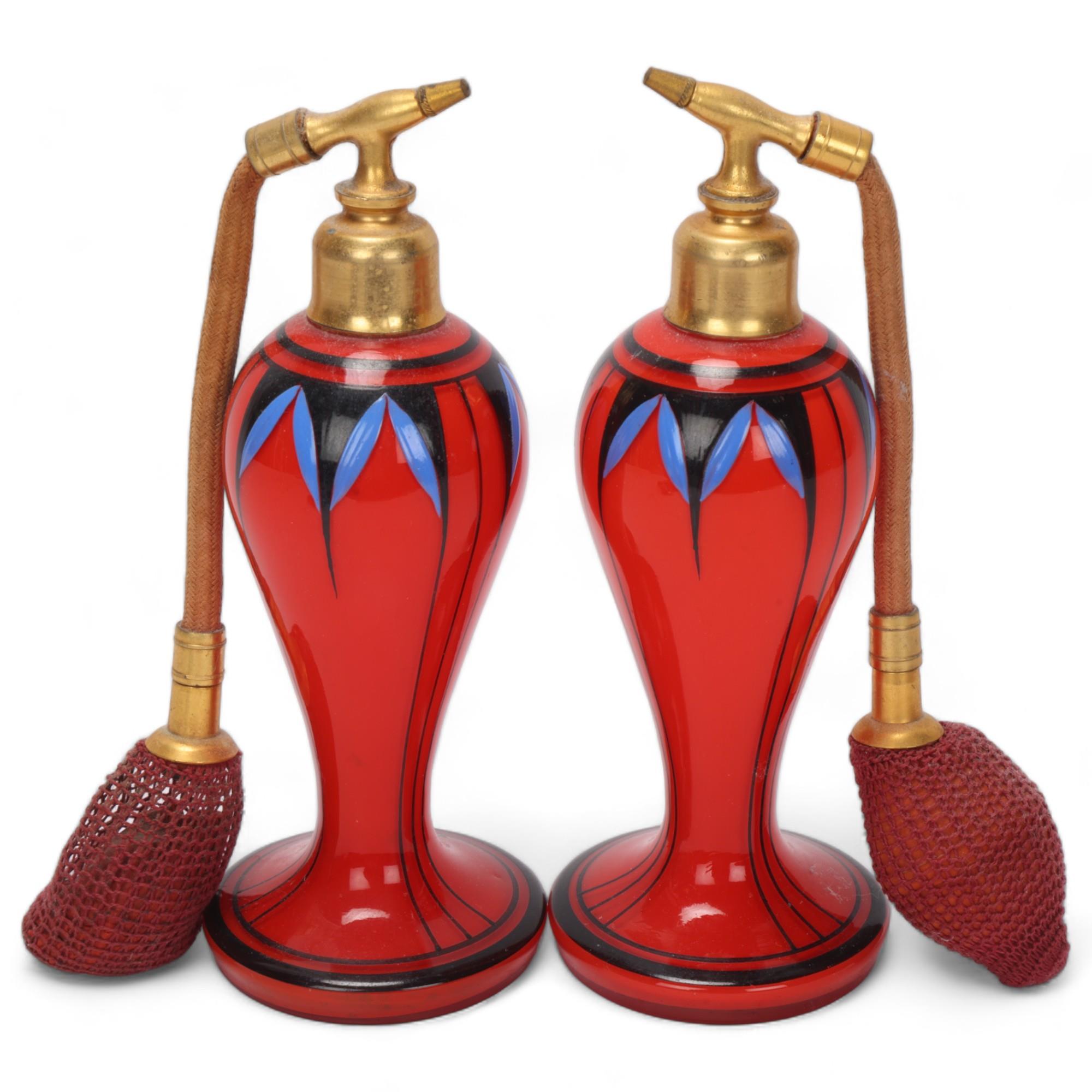 Pair of Art Deco red glass atomiser perfume bottles, with painted decoration and gilt-metal