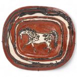 A mid 20th century earthenware charger, with slip glaze horse decoration, wire frame for wall-