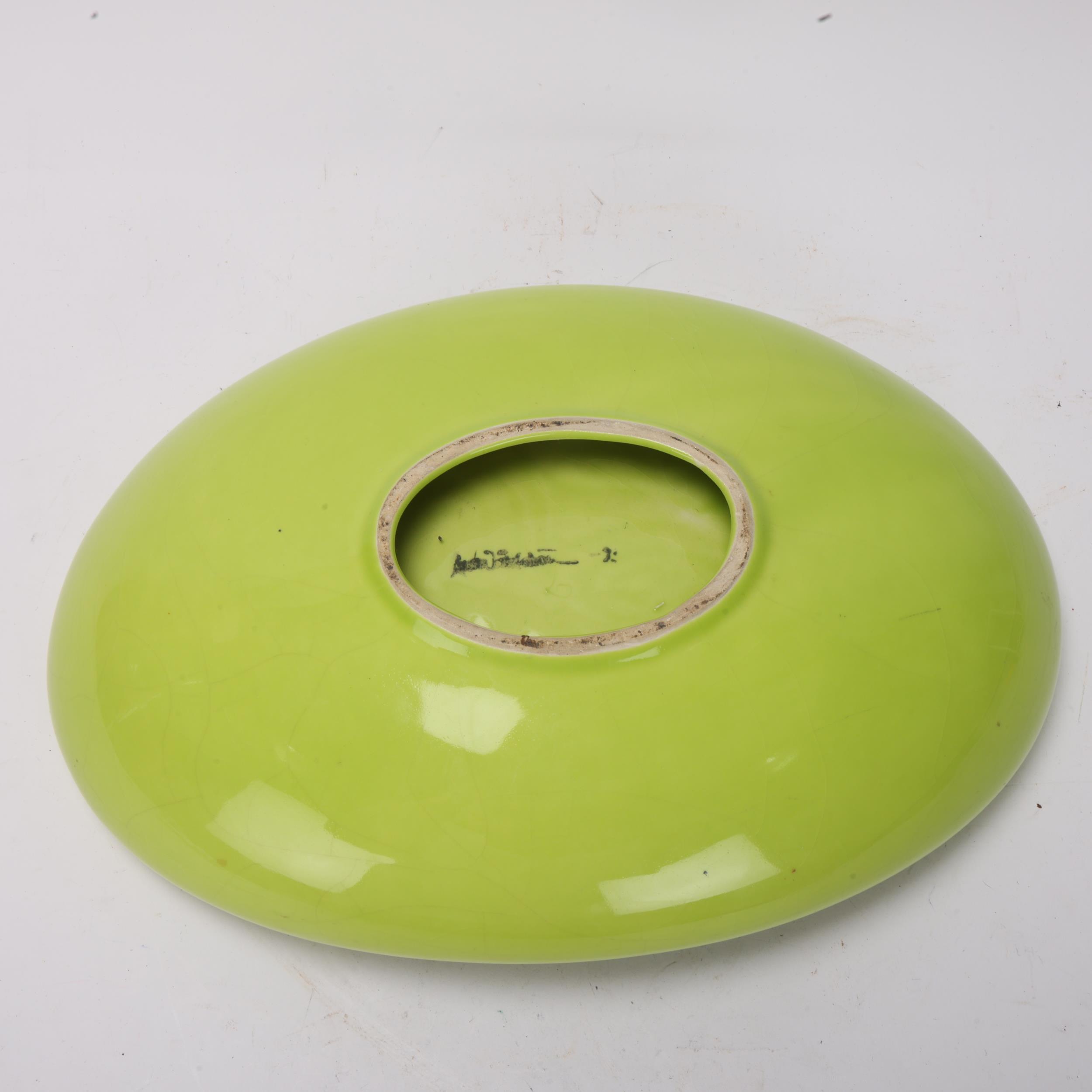 A mid 20th century elliptical centre dish with lime green glaze, indistinct makers mark under - Image 3 of 3
