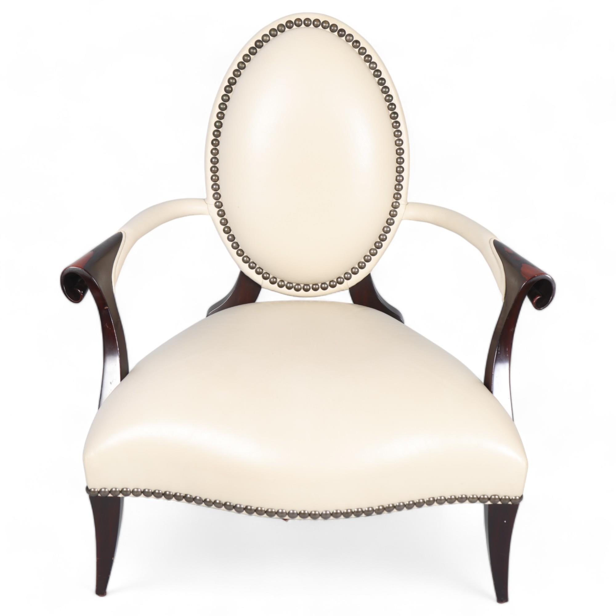 A Christopher Guy salon chair, white studded leather upholstery with silk-cut back to reveal red