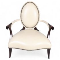 A Christopher Guy salon chair, white studded leather upholstery with silk-cut back to reveal red