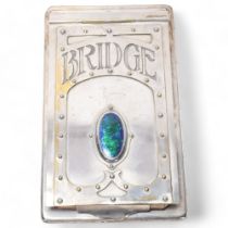 An Art Nouveau electroplate Bridge scoring pad, with hinged cover and inset peacock enamel panel,