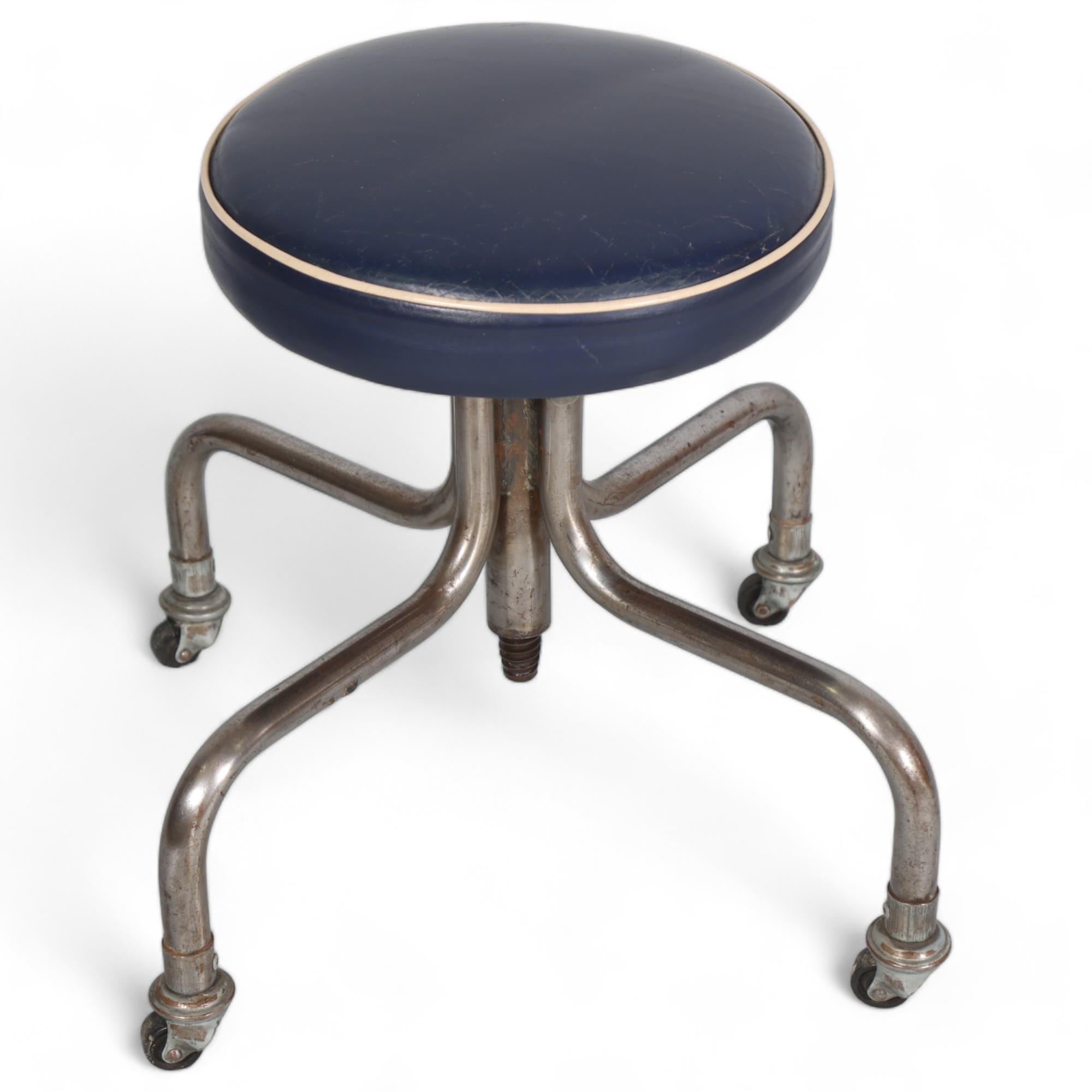 A mid-century modernist tubular steel industrial height adjustable stool with blue leather seat,