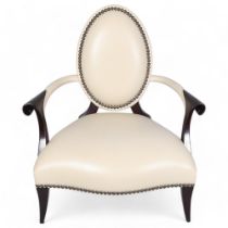 A Christopher Guy salon chair, white studded leather upholstery with back slit to reveal red