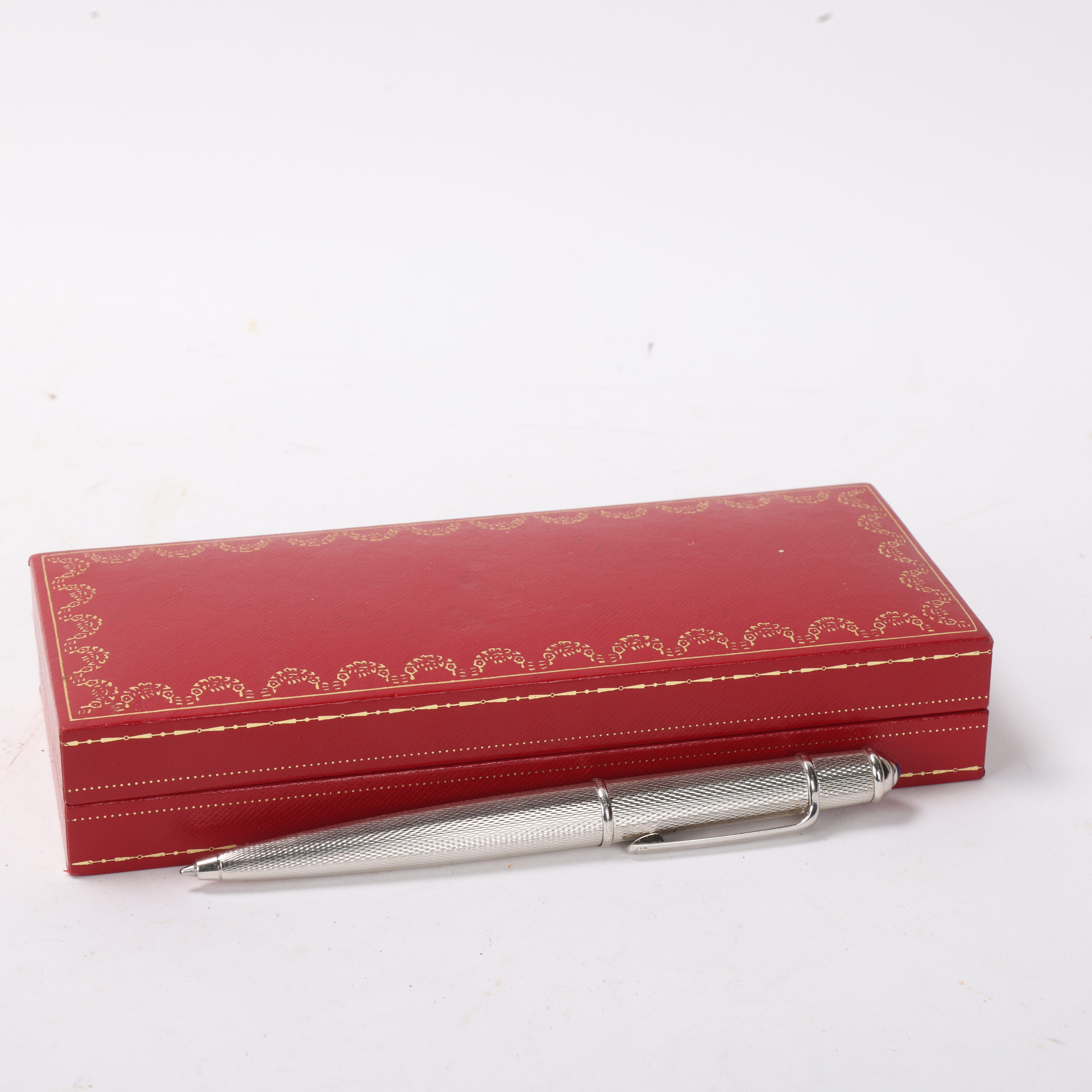 A Cartier "Diablo de Cartier" ballpoint pen, with engine turned steel body, original box and papers - Bild 2 aus 3