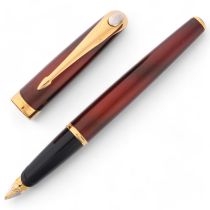 A Parker Ellipse fountain pen, 18k gold nib, red lacquer body with gold plated mounts, in