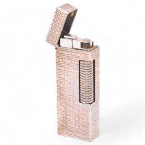 A vintage Dunhill Rollagas lighter, with silver plated textured body, makers marks to base, length